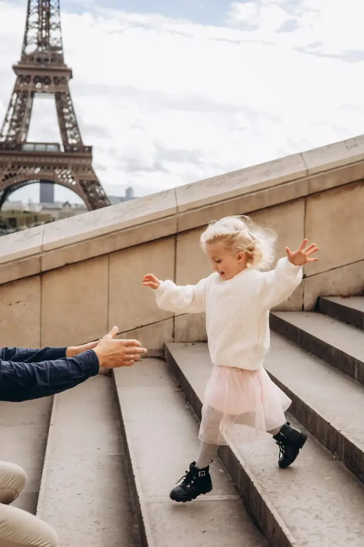 Child running Trocadero stairs Eiffel Tower Paris