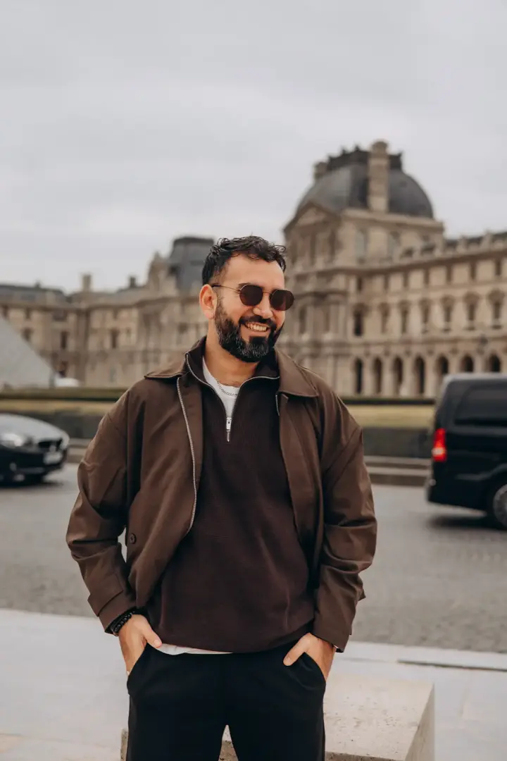 Man sunglasses brown jacket Louvre Paris casual portrait