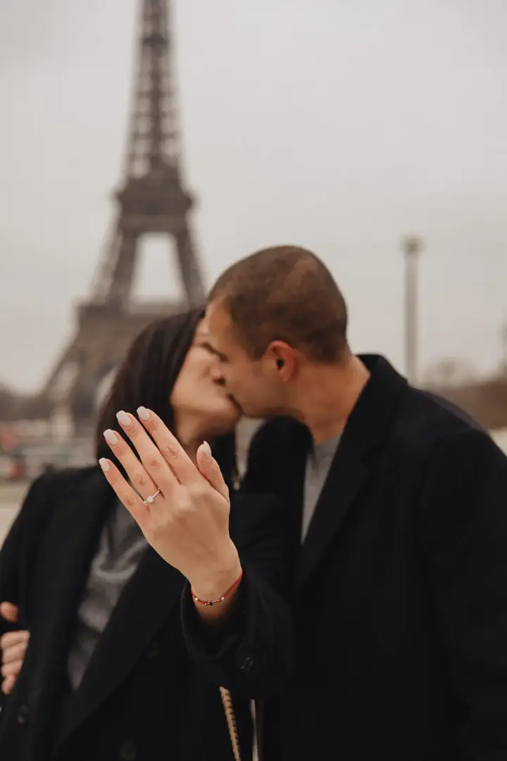 She said yes ring on hand kiss Eiffel Tower Paris