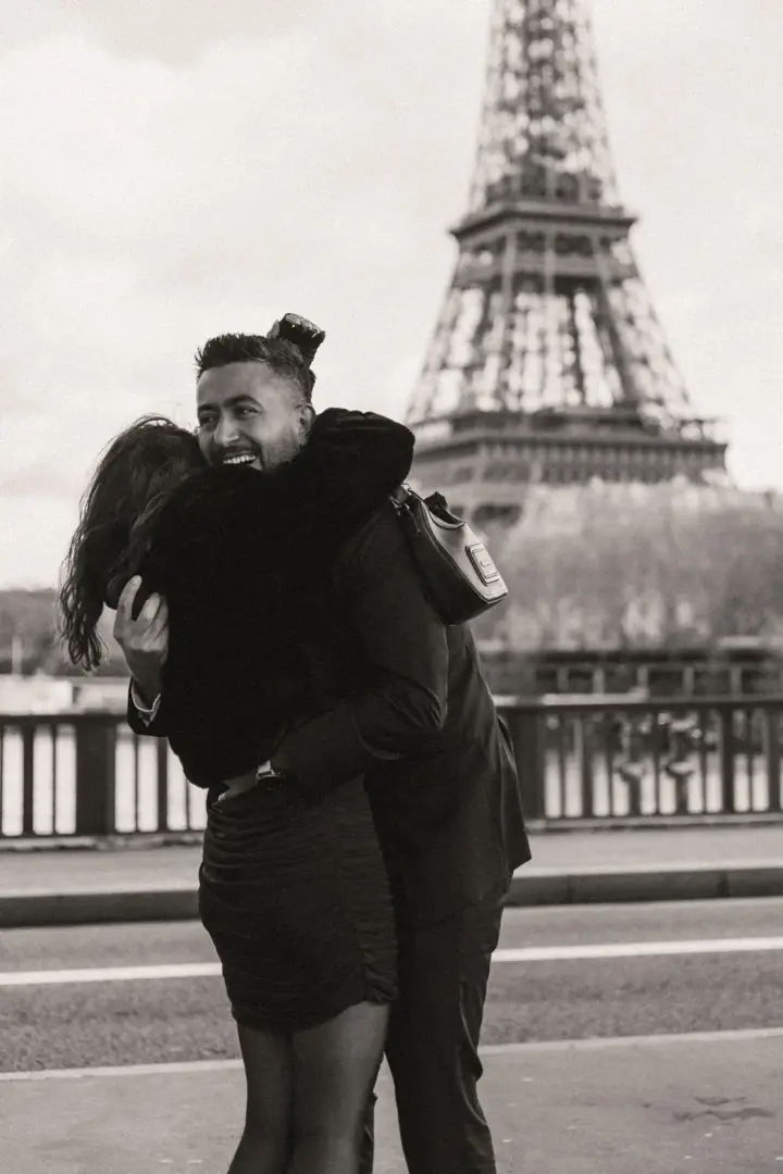 Joyful hug after proposal Eiffel Tower Paris black white