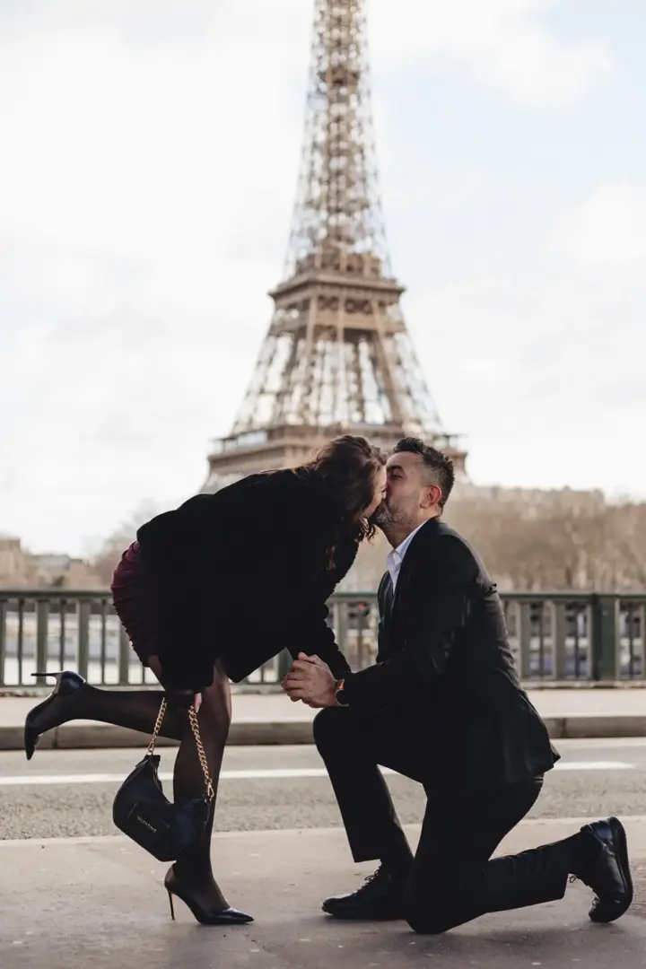 Proposal kiss on knee Eiffel Tower Paris day