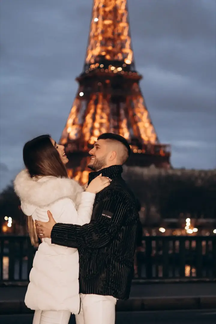 Couple embracing after proposal night Eiffel Tower Paris